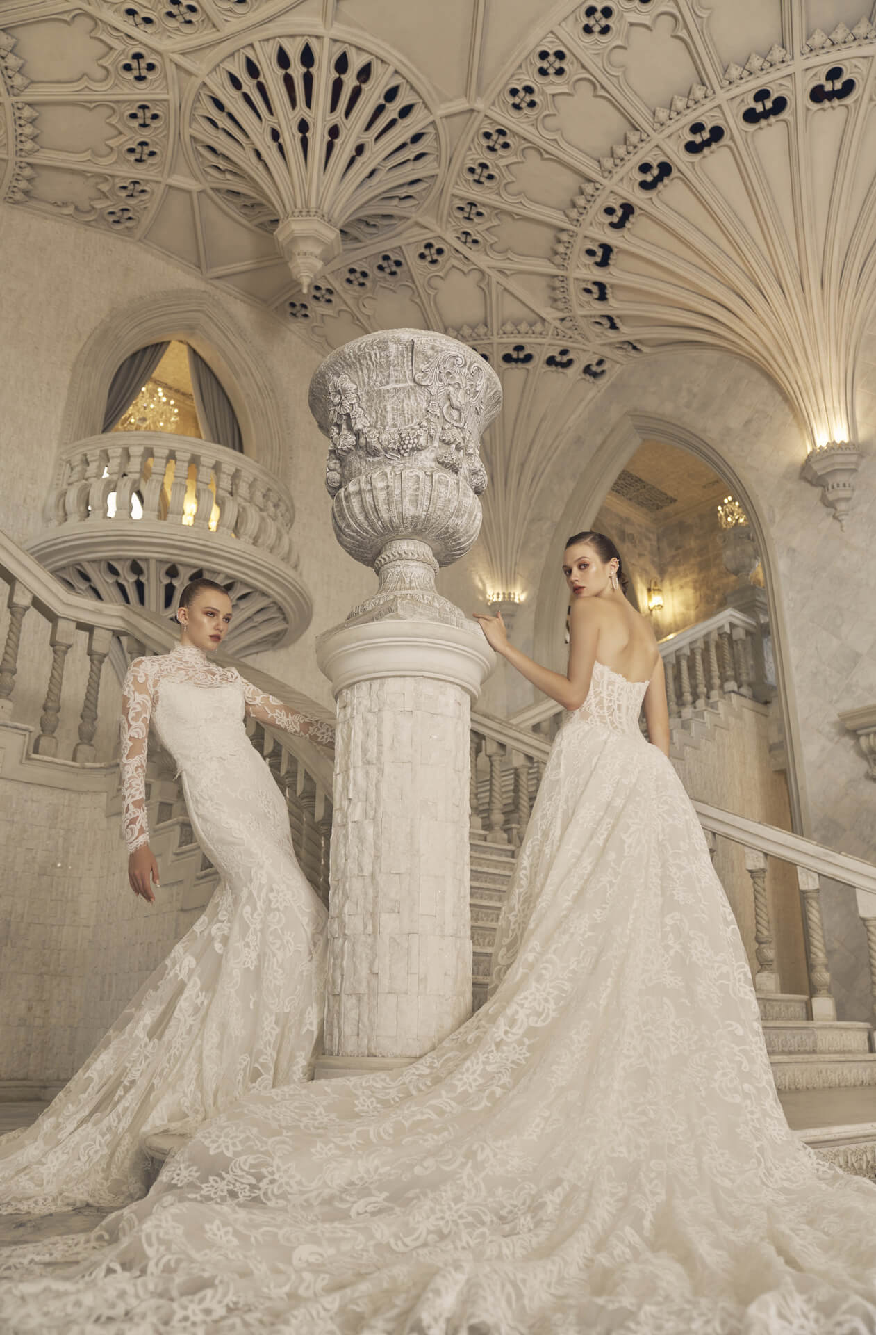 A wedding dress with a high neck and sleeveless design, featuring a structured bodice and a flowing skirt, displayed in a grand, white-themed wedding venue with intricate architectural details exhibition at the One Fine Day Bridal Market New York