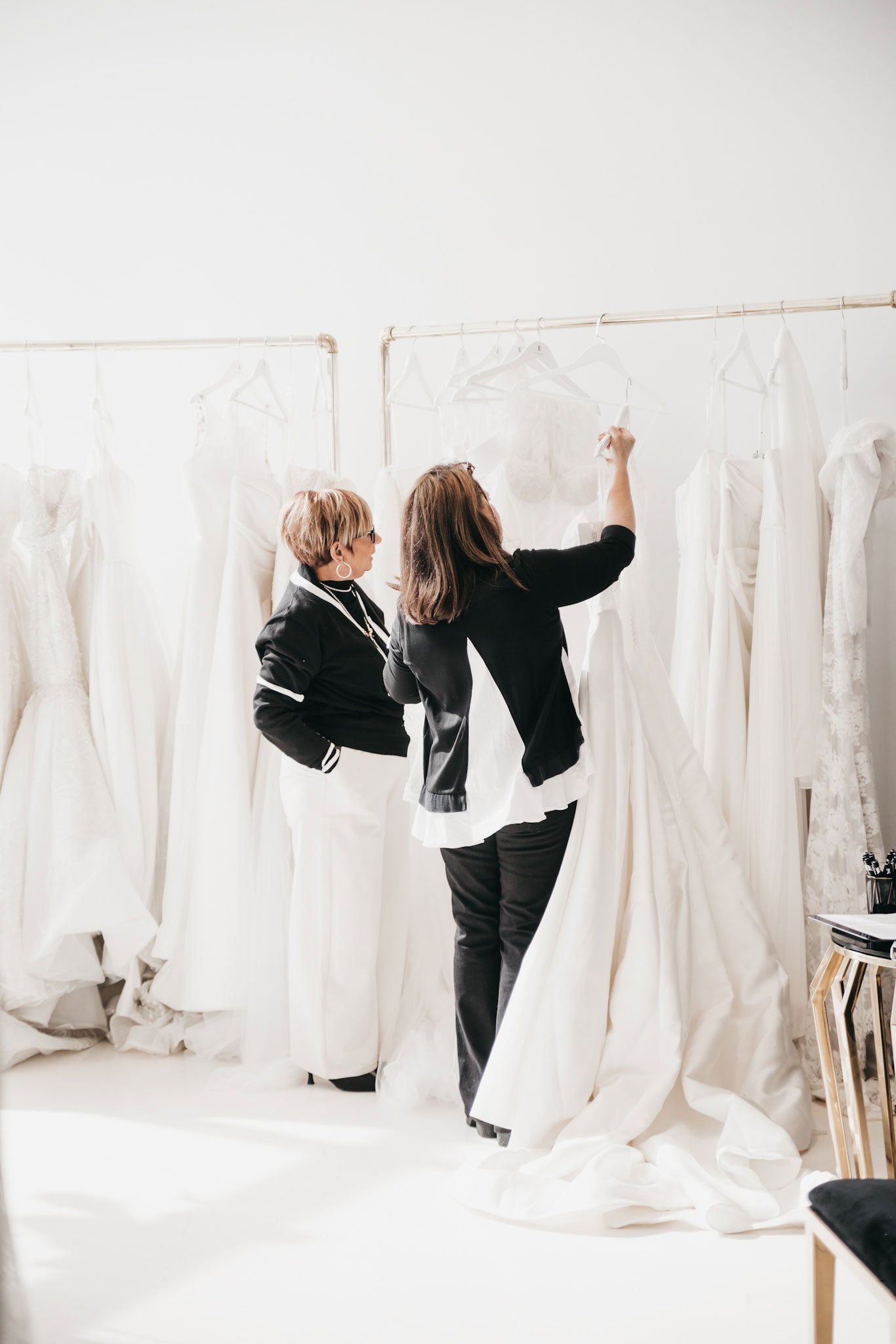 Two buyers browsing for wedding dresses and bridal gowns at the bridal market in new York